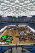 The pit party at Domination in the Dome in Pontiac Michigan. The ride truck Raptor is giving rides in the corner of the track.