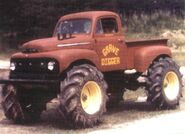 The Red Ford Grave Digger with tractor tires.