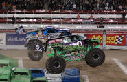 Grave Digger wins racing over Bounty Hunter at World Finals 7 with the Green Ghost design