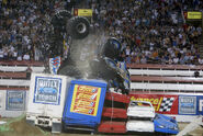 Madusa knocking Bounty Hunter off of the trailer obstacle during its winning freestyle performance at Monster Jam World Finals V.