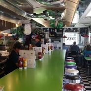 Interior of Diggers Diner, with Grave Digger hoods on the ceiling.