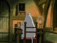 Moomintroll sitting down reading