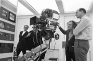 On set of Breakaway in December 1973, filming Valerie Van Ost. L-R: Reg Hill (in blazer), Lee H. Katzin (with pipe), Frank Watts, and Gerry Anderson.