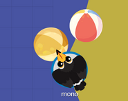 A Toco Toucan with a golden beachball beside a regular beachball.