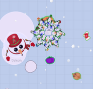 A Snowman by a decorated fir tree