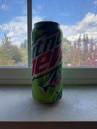 A photograph of a contemporary 16 oz. can of Mountain Dew.