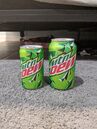 A photograph of contemporary 7.5 oz. & 12 oz. cans of Mountain Dew.