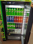 Various Mountain Dew flavors in a store fridge.