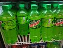 Contemporary Mountain Dew Sidekick bottles in a store cooler.