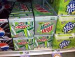 Photograph of three contemporary Diet Mountain Dew 12-packs along with a 12-pack using the previous design.