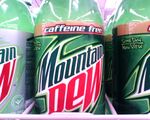 Contemporary Caffeine-Free Mountain Dew and Diet Mountain Dew 2 Liter bottles on a store shelf.