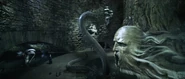 Harry engaging the Basilisk atop the Slytherin statue.