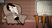 The "new" Mr. Bean watching TV. At Mr. Bean's home.