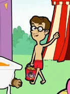 Declan holding a red bucket filled with slop to feed them to the donkeys.