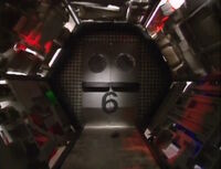 A pair of doors with circular windows that open away from the camera, and to the camera when closing. Note: This door also shows a cockroach zipping by on the floor, both when opening and closing. From episode 812 onward, the sound effects when closing later changed. This was designed by Jef Maynard and Trace Beaulieu to resemble a hospital door, as a nod to the birth sketch in Monty Python's The Meaning of Life.[1]