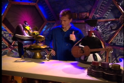 Tom tries to play guitar