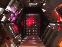 A door with holes cut in it, pink lighting, and bubbles floating that opens by sliding up when opening, and sliding down when closing. If one looks closely it is possible to see the number 3 in bright pink. Door 3 is surrounded by a Doctor Forrester figure, a Mr. Peabody figure, and the packing material from daisy-wheel printer fonts. [1]