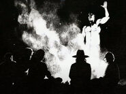Judge Holden explaining a campfire story with Dutch's bunch.