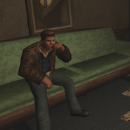 Romano smoking on couch.