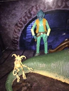 An imp creature sitting on the Hutt's tail while Greedo doesn't seem too fond of that.