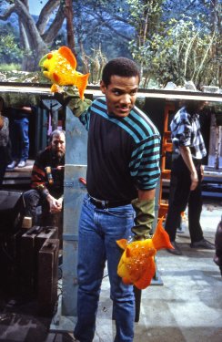 Kevin Clash with fish on both hands, Jim in the background