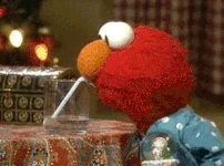 Elmo drinks a glass of water in Elmo Saves Christmas