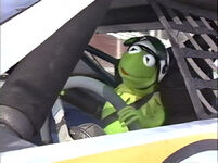 Kermit in a race car in Muppets on Wheels