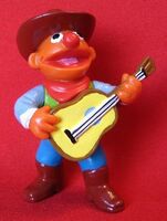 Ernie dressed as a cowboy with a guitar