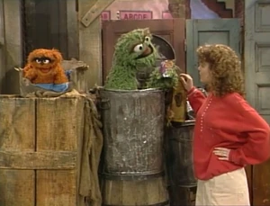 Oscar adopts a Grouch puppy named .