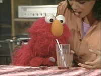 Elmo drinks two glasses of grape juice in Sesame Street Episode 2300