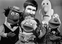 Harrison with Jim Henson and some other Muppets of the time.