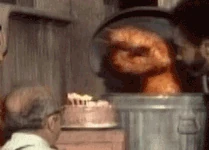 Oscar the Grouch blows out birthday candles in Sesame Street Episode 0007