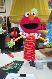 Elmo as a jack-in-the-box being built