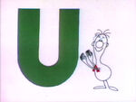 U -- A man gives an award to the letter U.