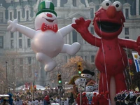 Elmo balloon at the 2008 6abc IKEA Thanksgiving Day Parade with a football and Frosty the Snowman balloon