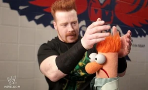 Sheamus fixes Beaker's hair.