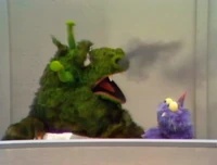 A monster blows smoke from his nostrils on The Ed Sullivan Show