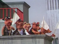 The pigs wave flags to surrender during the "Macho Man" musical number in The Muppet Show episode 405