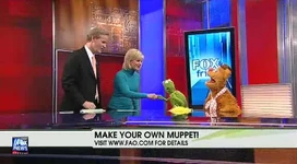 Carlson shakes hands with Kermit the Frog
