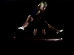 'Over' and 'Under' She vaults over one pommel horse, rolls under another one, then repeats everything in slow motion. (First: Episode 0517)