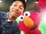 Pharrell takes a selfie with Elmo