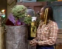 Oscar the Grouch uses a pipe as a part of a photoshoot in Episode 1591.