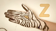 Man paints on hand: Z - Zebra (EKA: Episode 4325)
