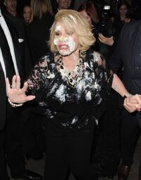 Joan Rivers fleeing the Red Carpet party after her tussle with Miss Piggy