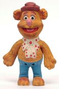 Fozzie in hat, tie, and blue pants