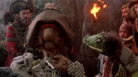 Mudwell holding Dead Tom in Muppet Treasure Island