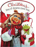 A Christmas wall decoration featuring Kermit dressed as Santa Claus, with Miss Piggy 1981