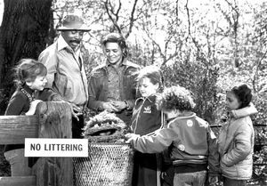 Oscar goes spelunking in a  wastebasket.