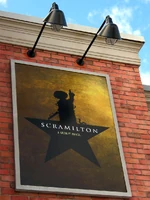 Hamilton spoof poster in the waiting queue