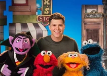 Colin Jost with the Count, Elmo, Zoe and Cookie Monster